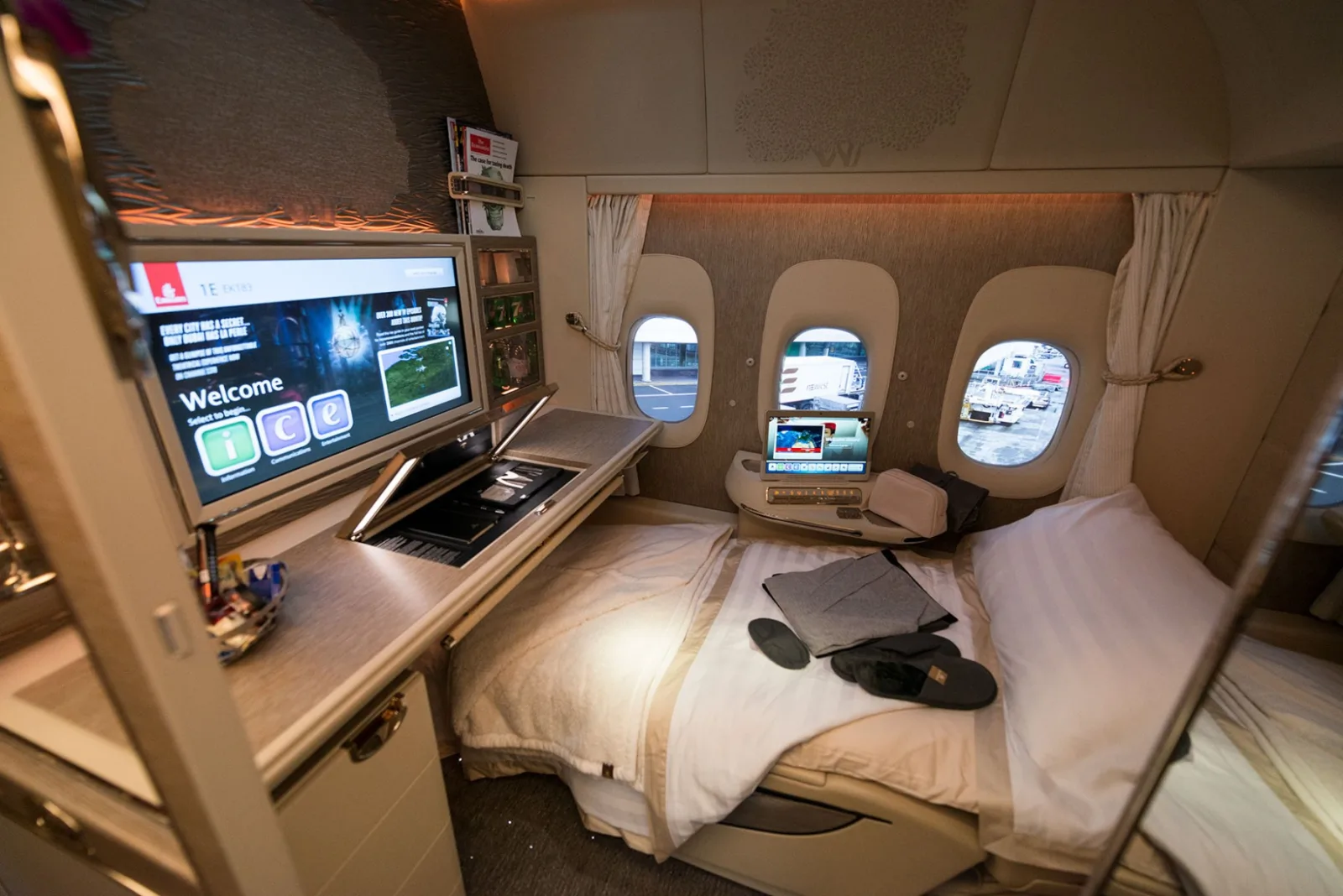 A first class suite in bed mode with the privacy door closed, the redemption tier that produces outlier cents-per-point results.