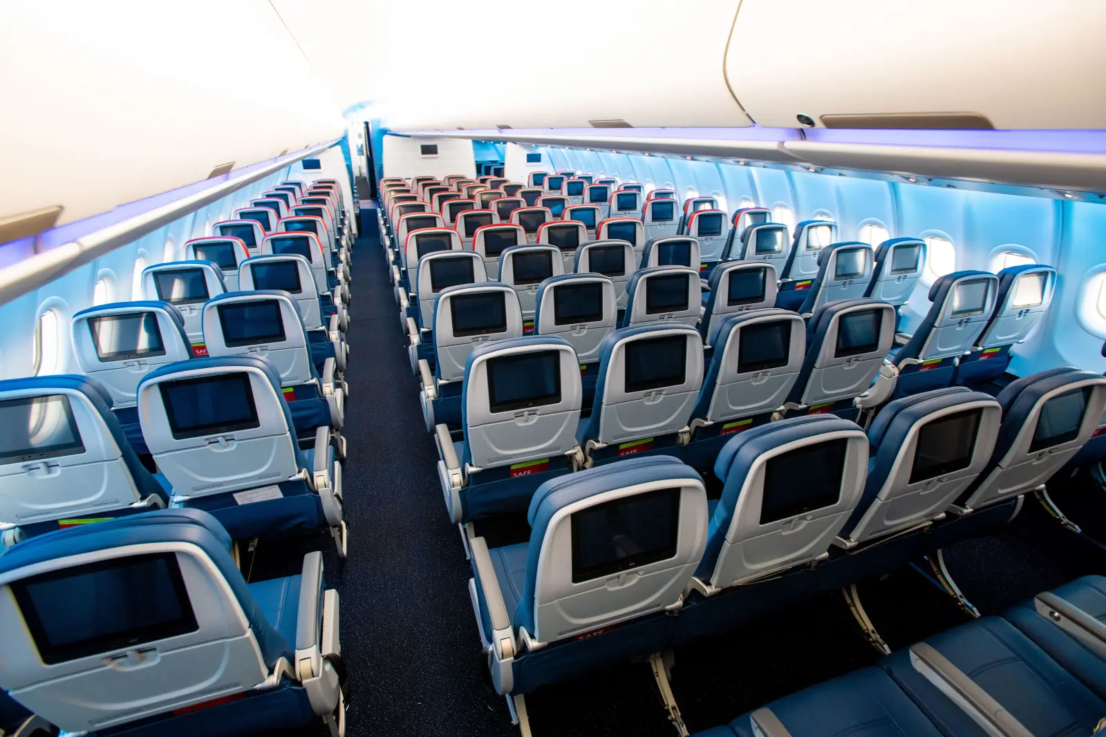 A wide-body economy cabin photographed down the aisle, the cash fare a points redemption is normally measured against.